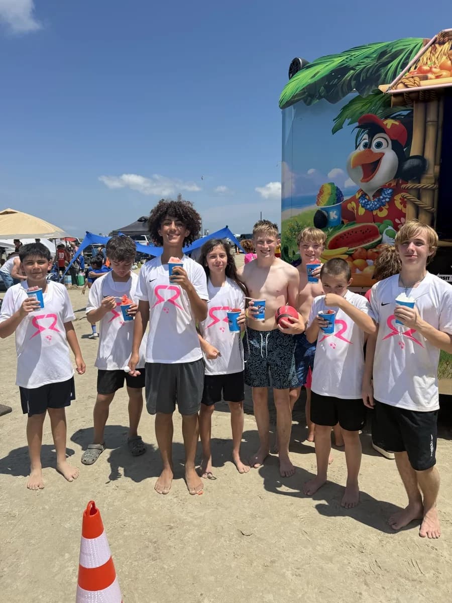Players in white SOLO shirts holding snow cones during the tournament weekend
